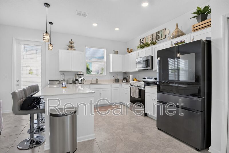 Stunning modern town home in Champions Gate with fence enclosed yard! property image