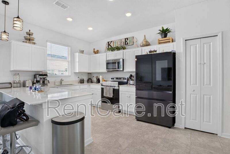 Stunning modern town home in Champions Gate with fence enclosed yard! property image